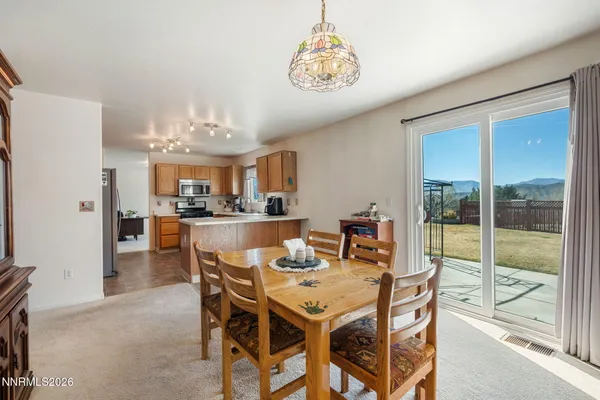 a view of a dining room with furniture window and outside view