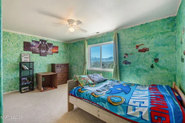 a bed sitting in a bedroom next to a window