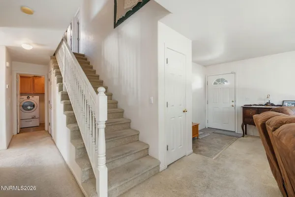 a view of a livingroom with furniture and stairs