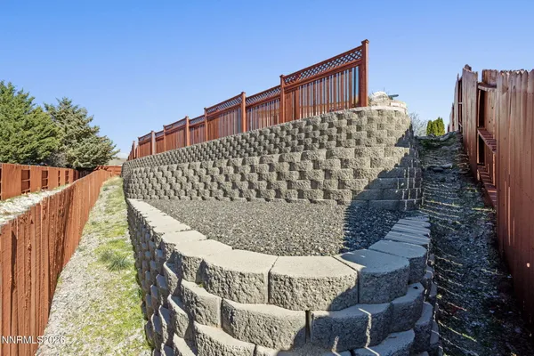a roof deck view with chairs and wooden fence