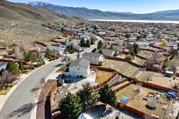 an aerial view of a house with a mountain