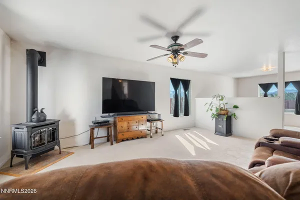 a bedroom with furniture and a flat screen tv