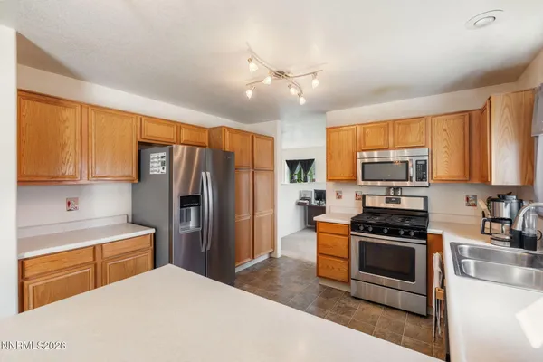 a kitchen with stainless steel appliances a refrigerator stove microwave and sink