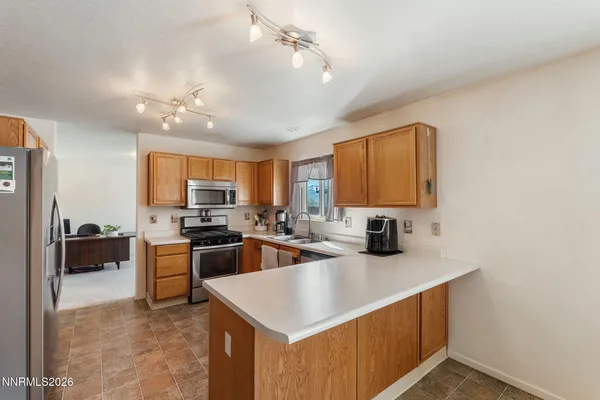 a kitchen with sink a stove and refrigerator