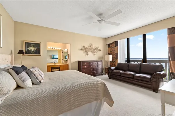 a bedroom with a bed couch and window