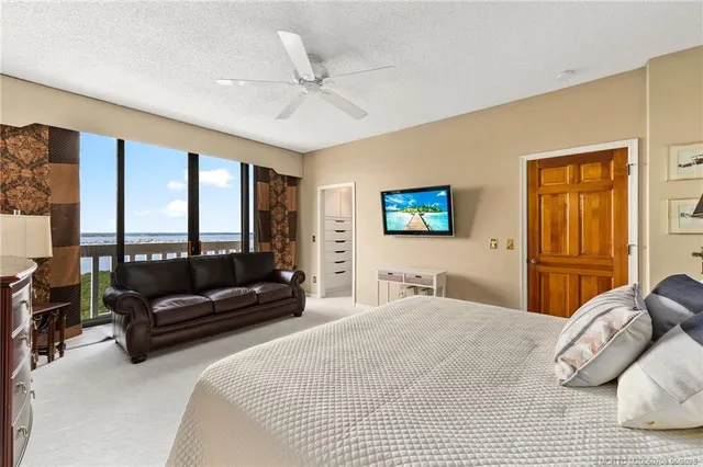 a bedroom with a bed and dresser with mirror