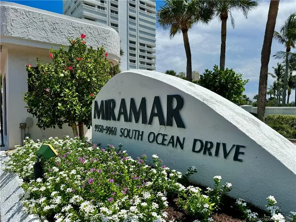a view of a sign board with potted plants