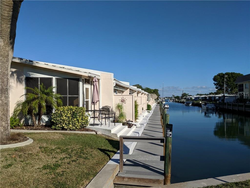 901 Gibbs Road, Unit 1 Venice, FL 34285 - Photo 1 of 1 a front view of a house with garden