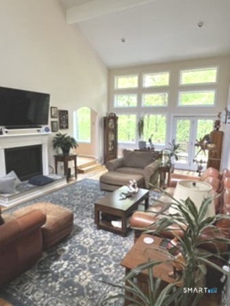 72 Pinnacle Road Ellington, CT 06029 - Photo 18 of 38 a living room with furniture fireplace and a large window