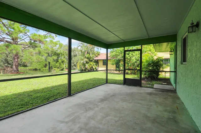 a view of a hallway with closet and a bathroom