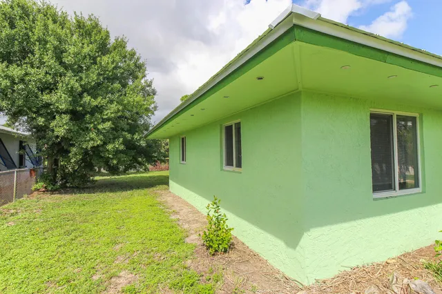 an empty room with a window and a ceiling fan