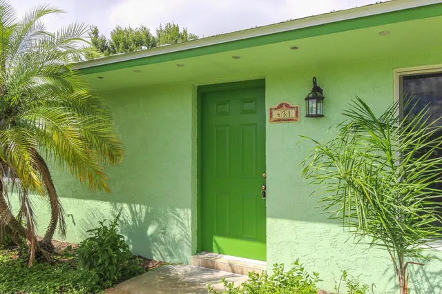 a green field with some trees in the background