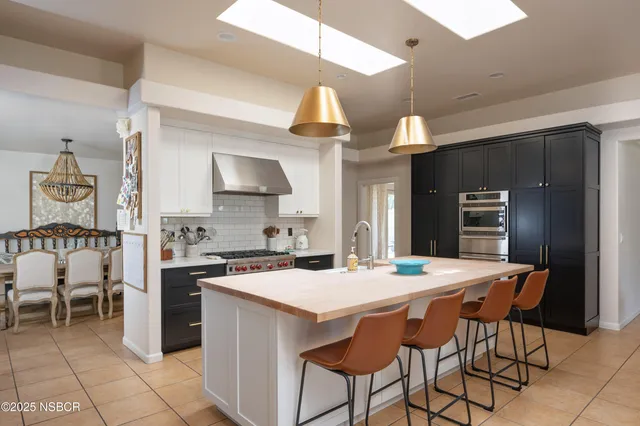 a kitchen with a dining table and chairs
