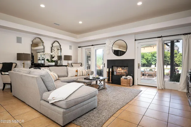 a living room with furniture and a fireplace