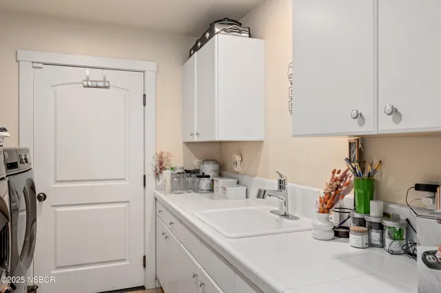 a kitchen with a sink and cabinets
