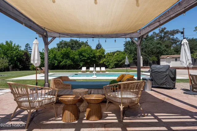 a view of a swimming pool with a couches in a patio