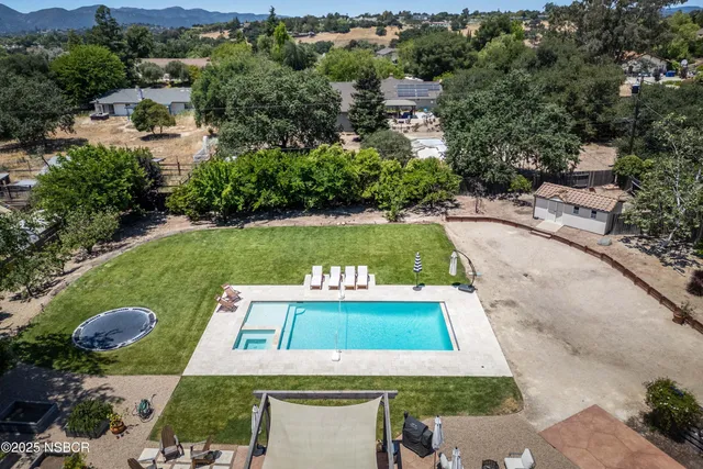 an aerial view of a house with a yard