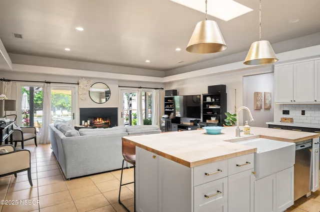 a view of living room with kitchen island furniture and a chandelier