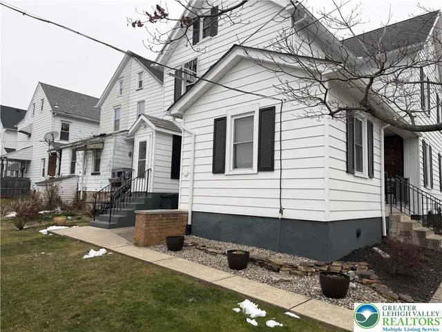 a view of a white house with a large windows