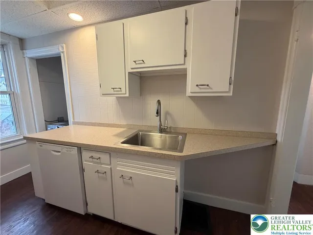 a kitchen with a sink and cabinets