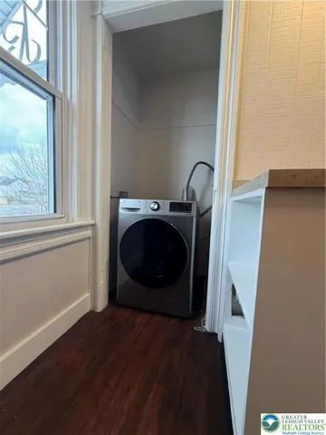 a view of a living room with a fireplace and wooden floor