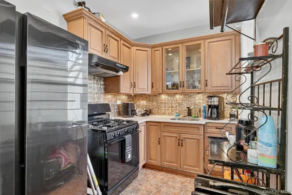 a kitchen with stainless steel appliances granite countertop a stove and cabinets