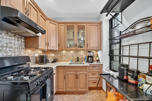 a kitchen with stainless steel appliances a stove a sink dishwasher and cabinets with wooden floor