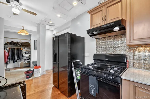 a kitchen with stainless steel appliances granite countertop a stove and a refrigerator