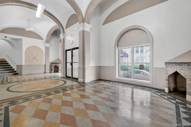 a view of a livingroom with furniture and staircase