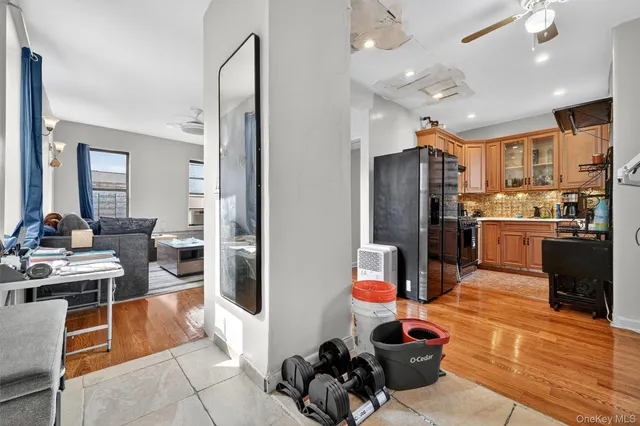 a kitchen with stainless steel appliances kitchen island granite countertop a refrigerator and a stove