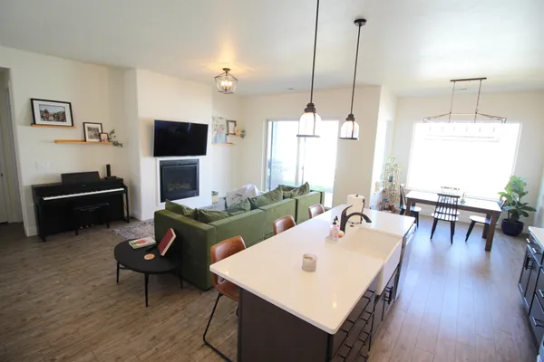 a living room with furniture a flat screen tv and a large window