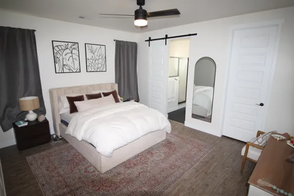 a bedroom with a bed and a chandelier