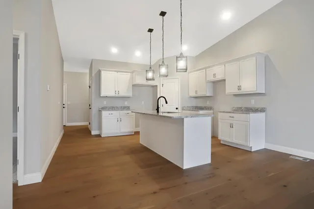 a kitchen with kitchen island white cabinets and white appliances