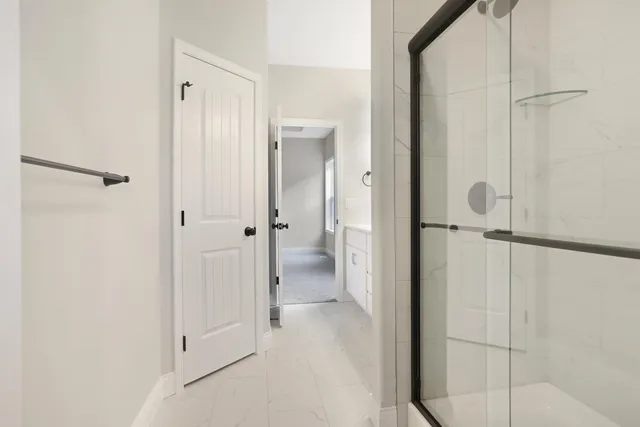 a view of a bathroom with a glass shower door