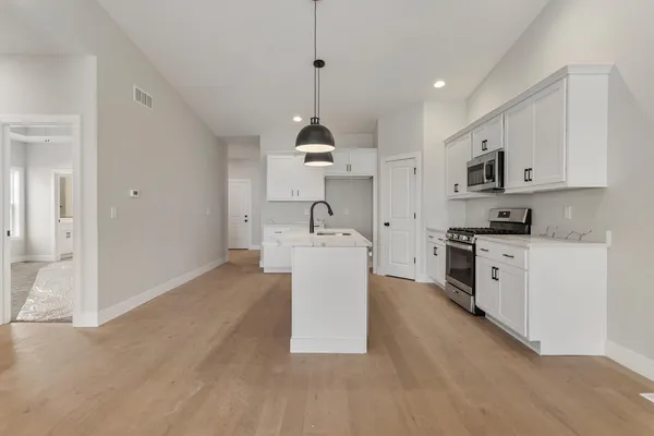a kitchen with a sink a counter top space and stainless steel appliances