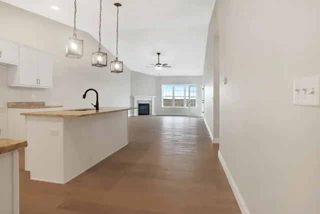a kitchen with kitchen island a sink and a refrigerator