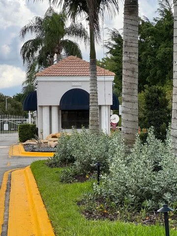 a front view of a house with swimming pool having outdoor seating