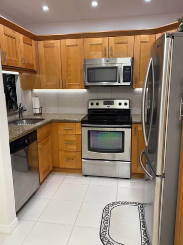 a kitchen with a stove a microwave and a sink