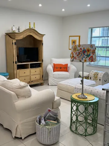 a bedroom with furniture and a potted plant