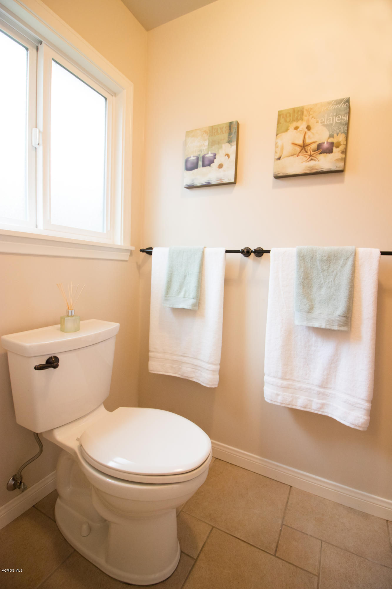 13671 Laurelhurst Road Moorpark, CA 93021 - Photo 23 of 32 a white toilet sitting next to a bathroom sink