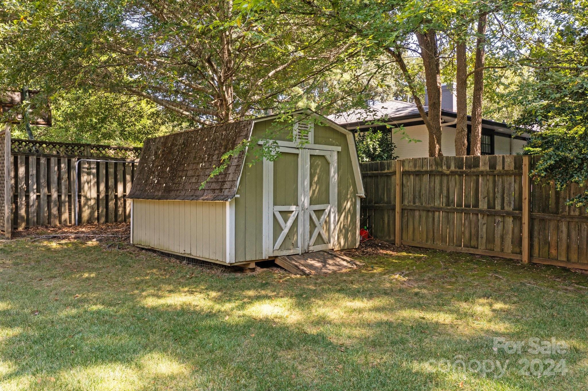1060 Churchill Road Davidson, NC 28036 - Photo 13 of 41 a view of a small house in the back yard