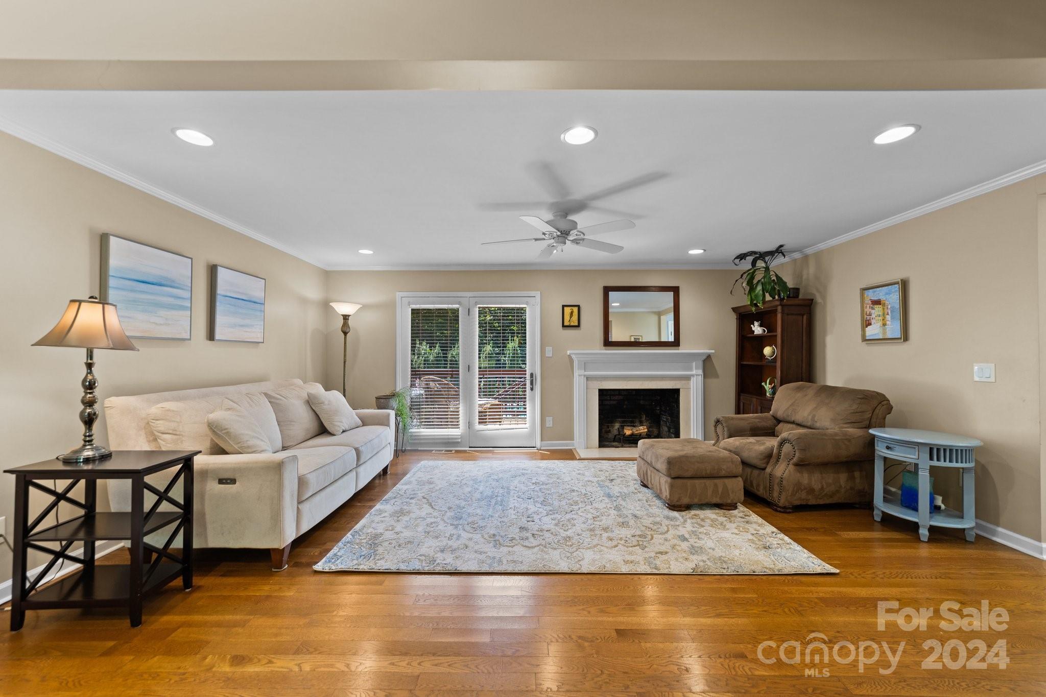 1060 Churchill Road Davidson, NC 28036 - Photo 16 of 41 a living room with furniture a fireplace and a large window