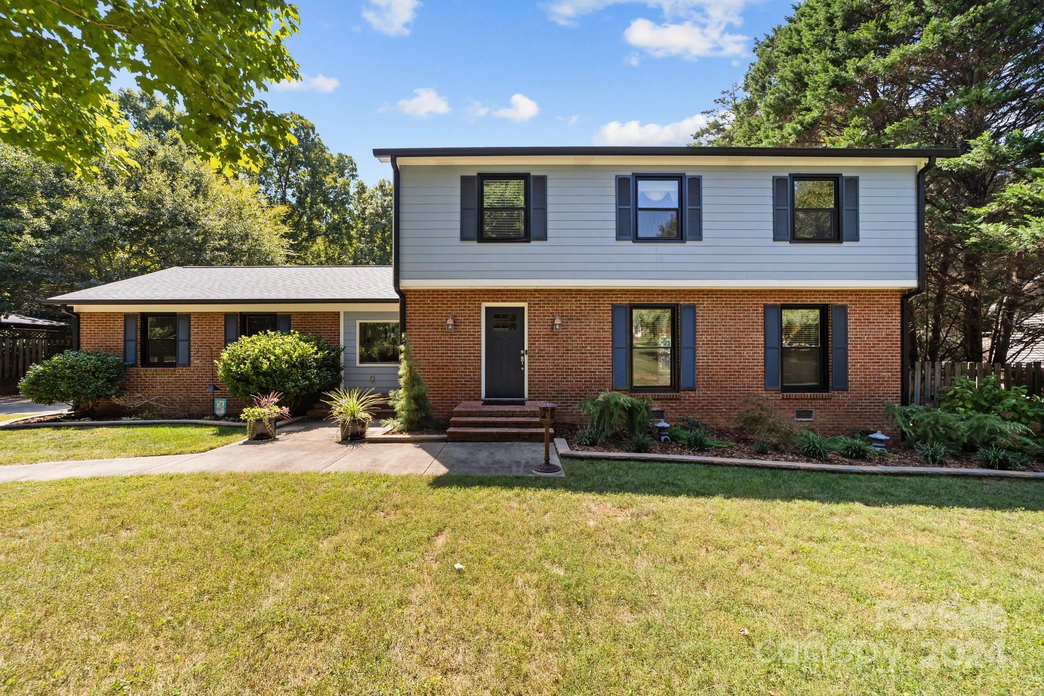 1060 Churchill Road Davidson, NC 28036 - Photo 2 of 41 a front view of a house with swimming pool and porch with furniture
