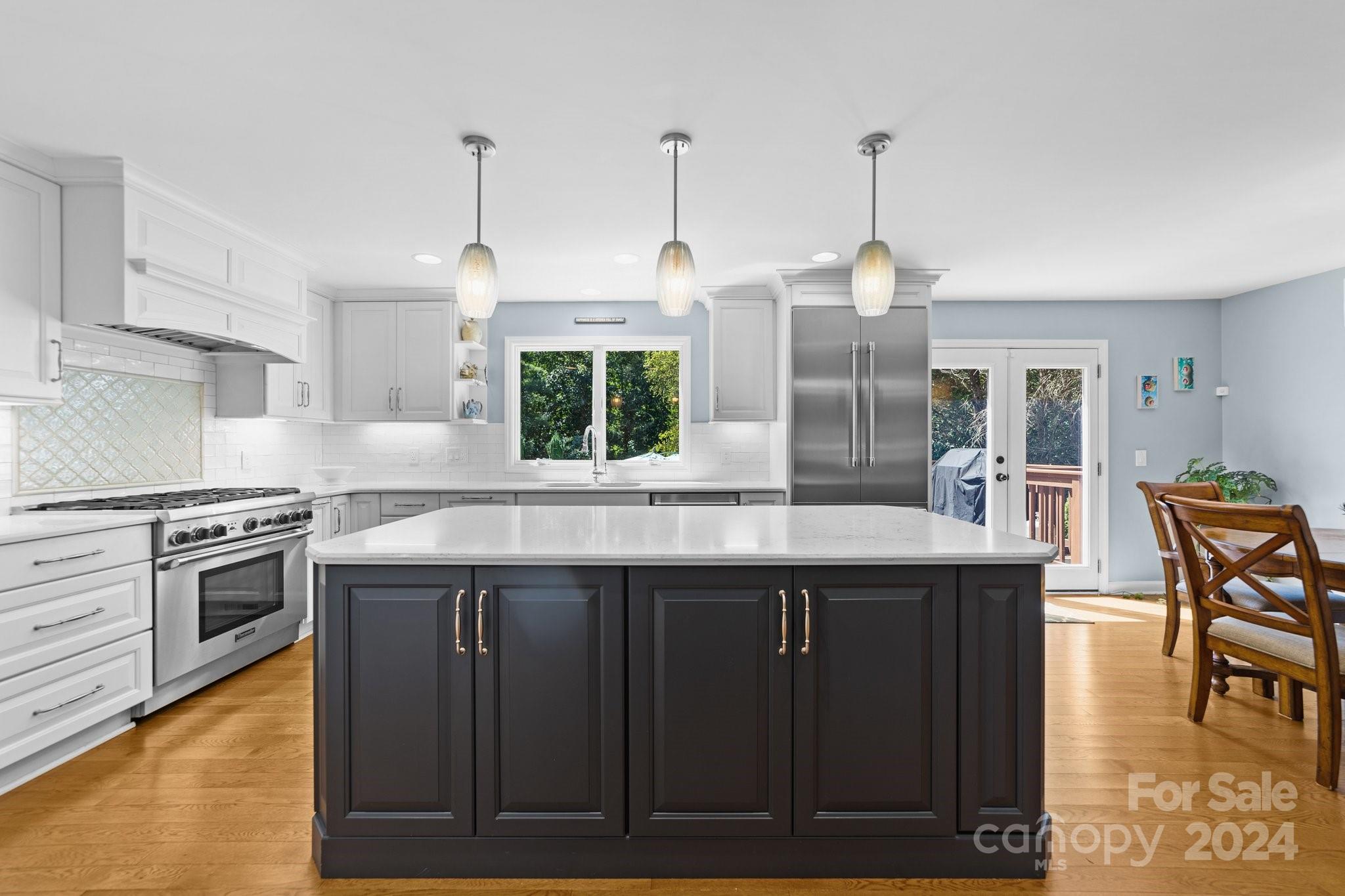 1060 Churchill Road Davidson, NC 28036 - Photo 21 of 41 a kitchen with stainless steel appliances granite countertop a stove a sink dishwasher and a wooden cabinets