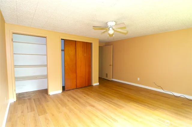 a view of an empty room with wooden floor