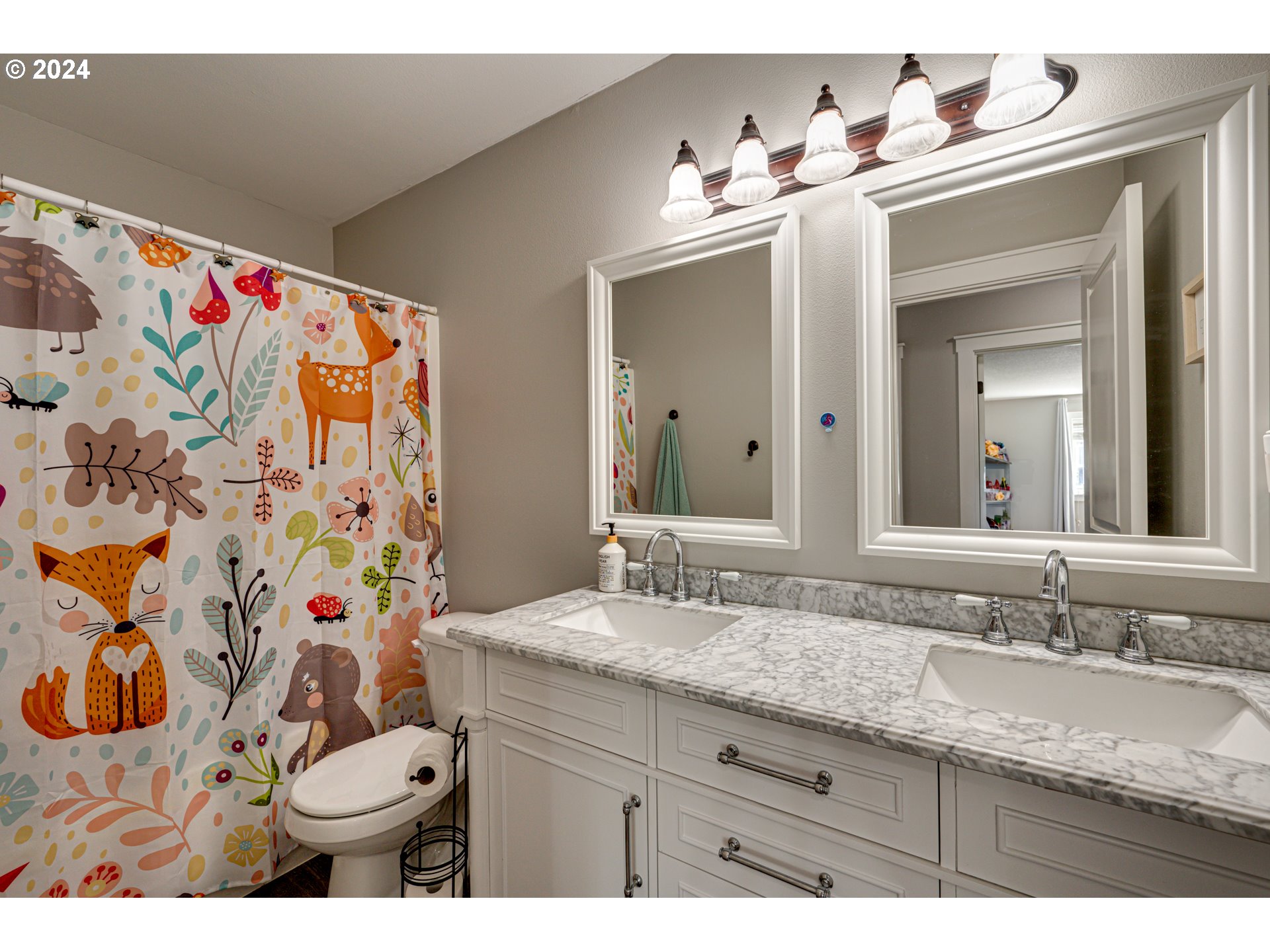 121 South 34th Place Ridgefield, WA 98642 - Photo 26 of 36 a bathroom with a sink vanity mirror and toilet