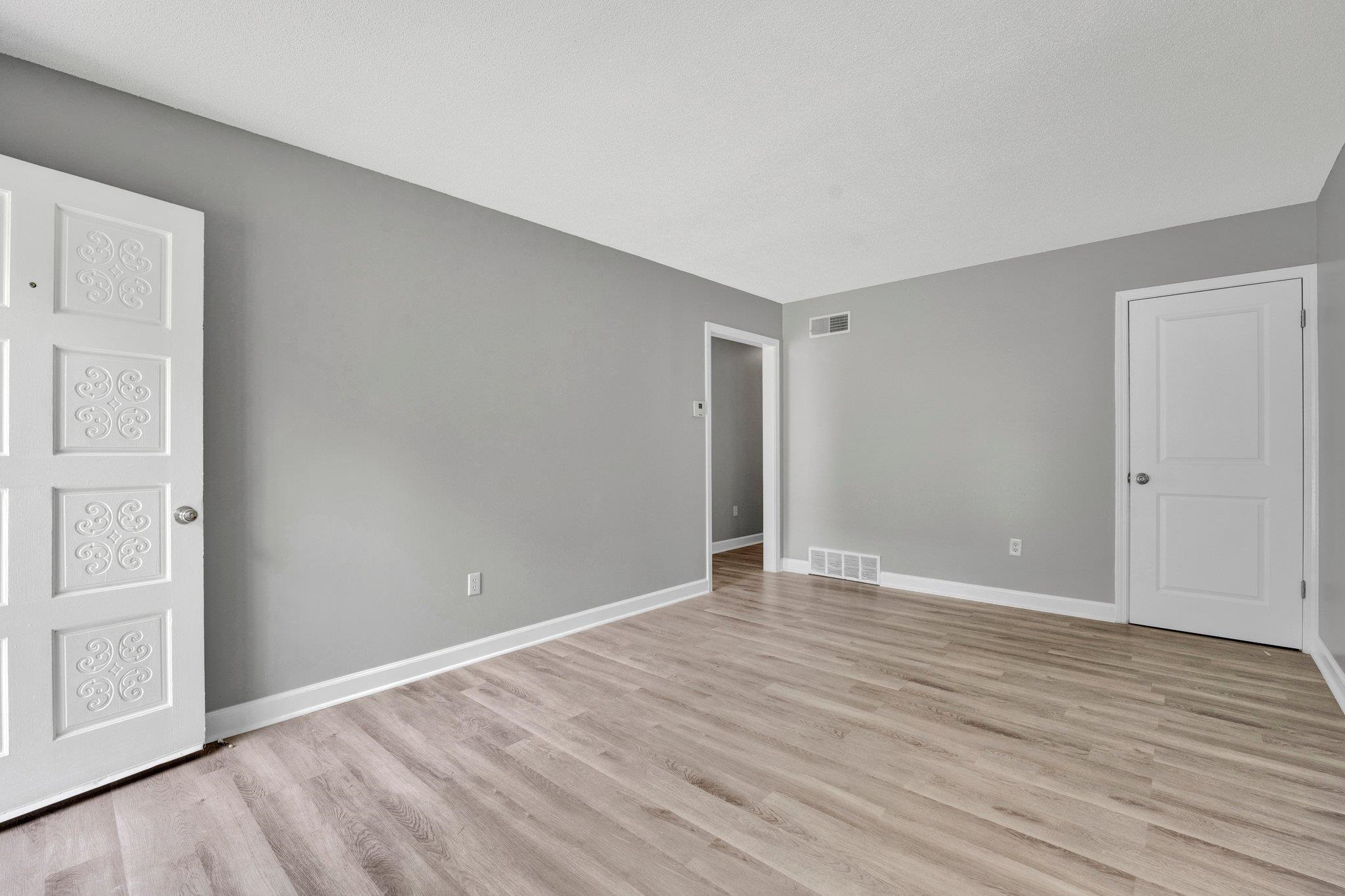 175 Stoneham Road Memphis, TN 38109 - Photo 4 of 25 a view of an empty room with wooden floor