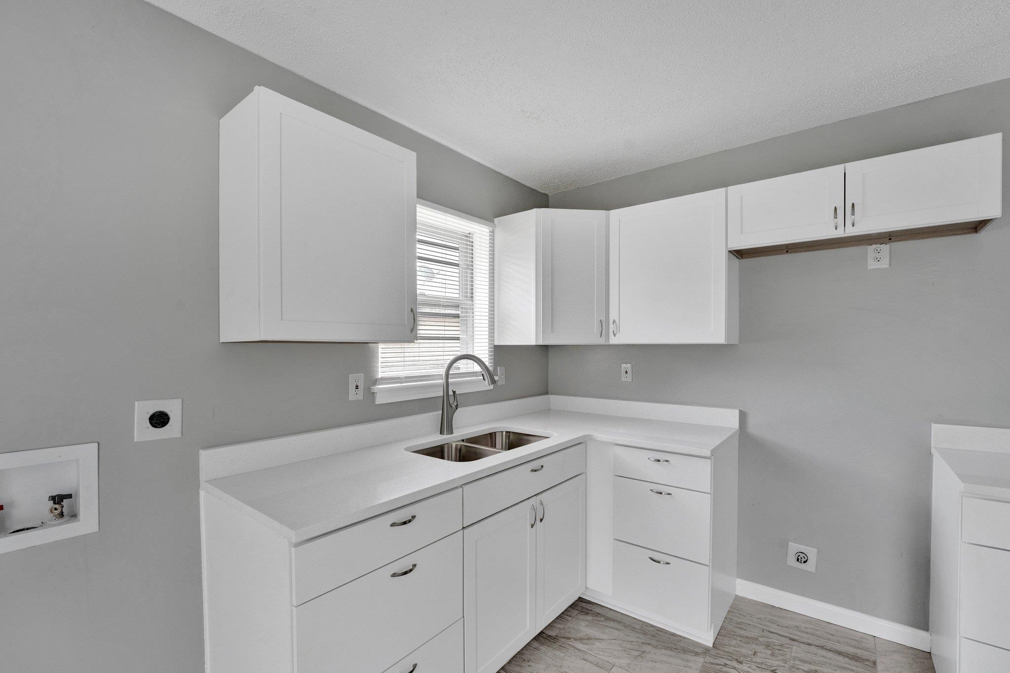 175 Stoneham Road Memphis, TN 38109 - Photo 7 of 25 a kitchen with white cabinets sink and dishwasher