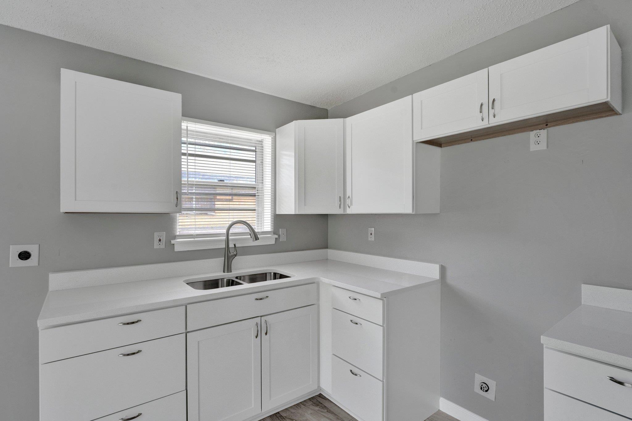 175 Stoneham Road Memphis, TN 38109 - Photo 8 of 25 a kitchen with white cabinets and a sink