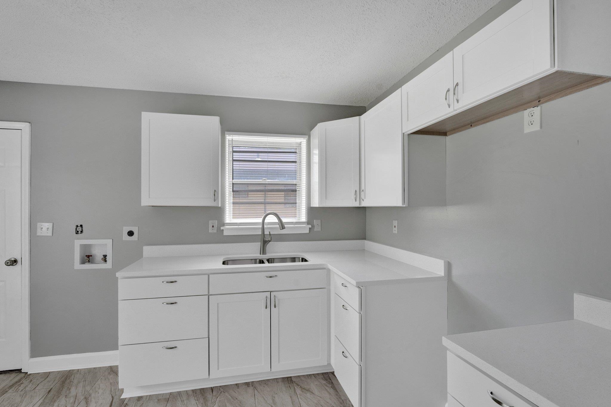 175 Stoneham Road Memphis, TN 38109 - Photo 9 of 25 a kitchen with a sink cabinets and window